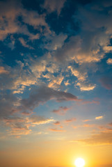 A great sun against the backdrop of the sunset clouds.