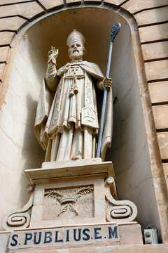 Statue of St Publius in an alcove on the front of the Parish church of our lady of sorrows, Bugibba, Malta.