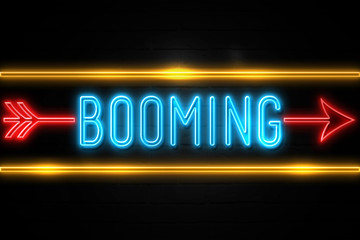 Booming  - fluorescent Neon Sign on brickwall Front view