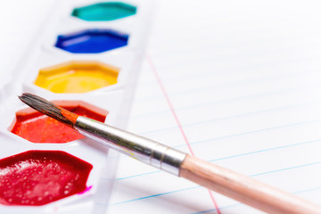 Brush and Bright colored watercolor paints. Back to school. Stationery.