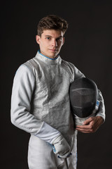 Smiling Young male fencer in white fencing costume