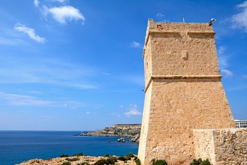 Fototapeta premium Ghajn Tuffieha watchtower overlooking the sea and cliffs, Golden Bay, Malta.