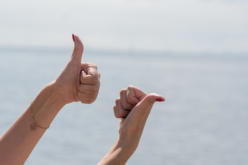 A woman's hand shows a gesture. Signs with fingers of a hand