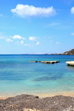 View of Ghaja Tehheiha Bay with a pebble beach in the foreground, Malta.