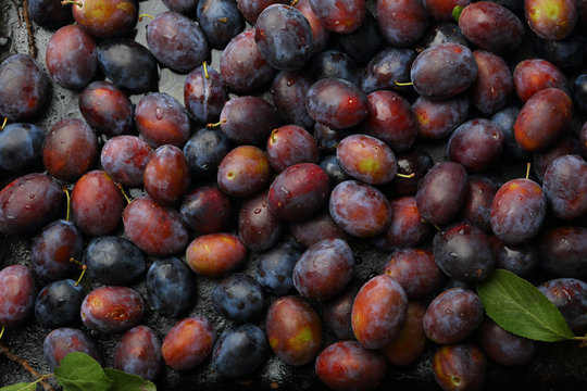 Dark food background with plums
