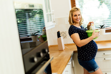 Pregnant woman working in kitchen