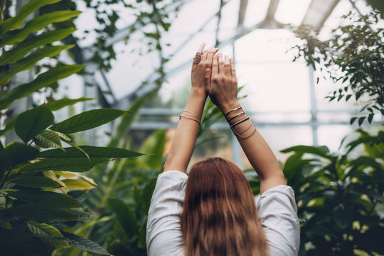 Female model standing inside greenhouse