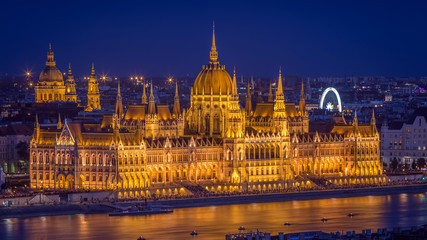 Fototapeta na wymiar Budapest, Hungary - Panoramic skyline view of the beautiful illuminated Parliament of Hungary and St Stephens Basilica at blue hour