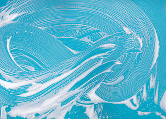 soap foam on a blue background - obrazy, fototapety, plakaty