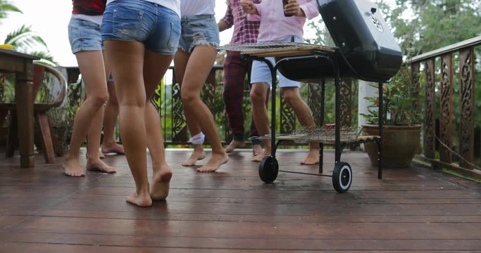 Young People Dancing While Cooking Barbecue Frineds Group Gathering On Summer Terrace Having Party Legs Closeup View Slow Motion 60