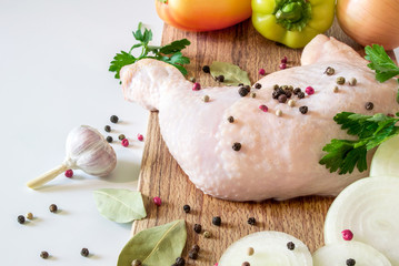 Chicken leg on wood near garlic
