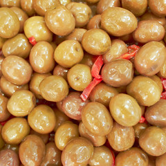 organic green olives in brine top view, tasty background