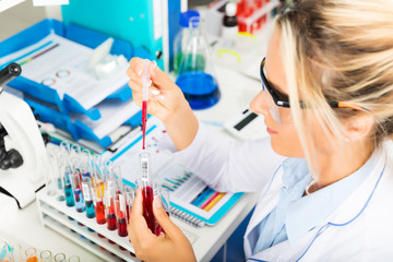 Young attractive woman scientist researching in the laboratory