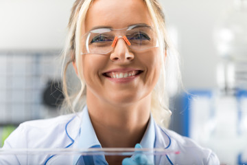 Happy young attractive smiling woman scientist in the laboratory