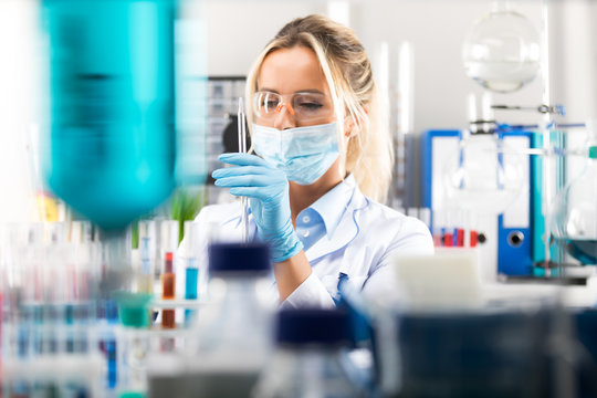 Young Attractive Female Scientist Preparing Laboratory Equipment For Tests