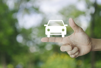 Car flat icon on finger over blur green tree background, Business service car concept
