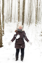 Young beautiful woman walking in a park forest in cold  winter air. Christmas girl. Good weather outdoors