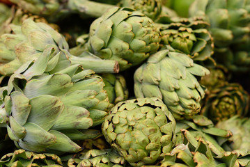 Fototapeta premium Ripe artichoke in the market. The concept of trade in vegetables and fruits, a farmer's fair.