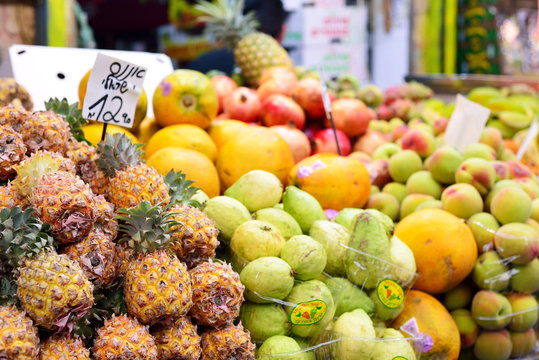 Market, exotic fruits on the counter, on the plate is written - pineapple.