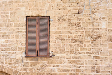 A closed window, an old stone wall.