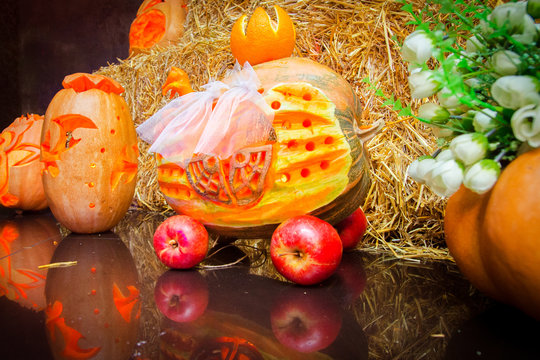Halloween. A curly head with a burning candle on the foton of the hayloft. The Feast of the Dead. Pumpkin. Ornaments from pumpkins