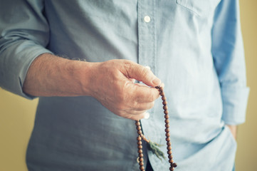 Man Counting Prayer Beads