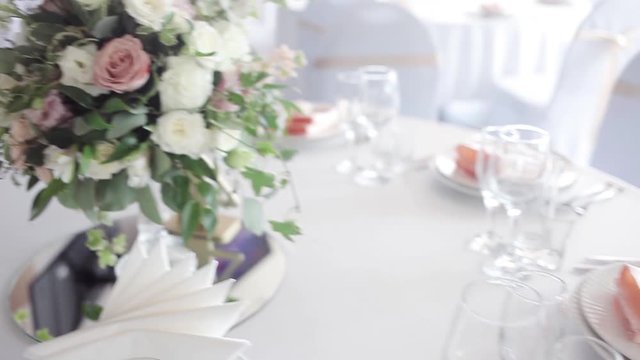 Wedding floristry. Beautiful bouquet on the table, dishes and served table