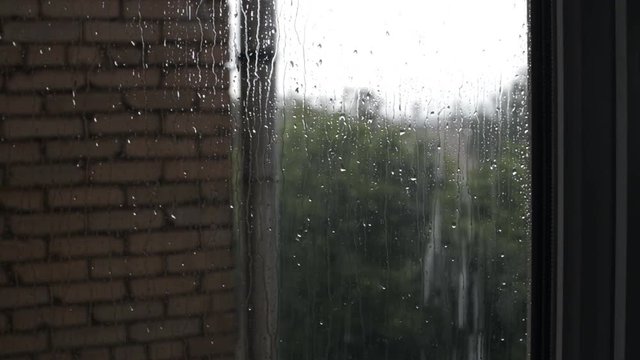 Close up drops of rain on window pane