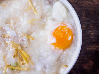 thai chinese asian rice porridge with pork and egg in bowl