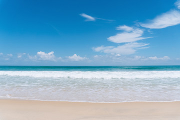 Tropical beach with blue sky and white cloud background.