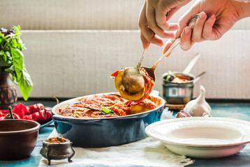 Ratatouille in a crockery on blue rustic background, serving a meal. .Classic French stew of autumn vegetables.