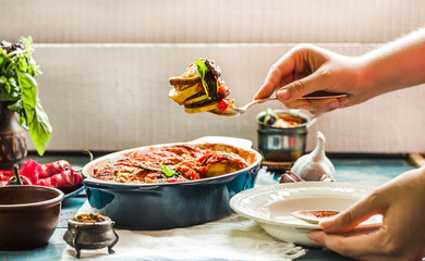 Ratatouille in a crockery on blue rustic background, serving a meal. .Classic French stew of autumn vegetables.