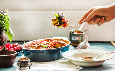Ratatouille in a crockery on blue rustic background, serving a meal. .Classic French stew of autumn...