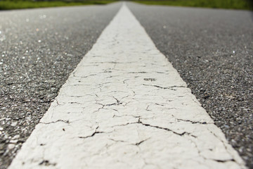 Obraz premium Retreating asphalt road macro background