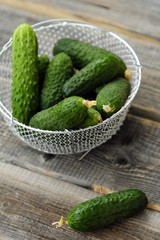 Fresh green cucumbers in a beautiful basket