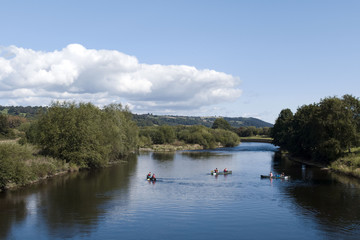 Fototapeta na wymiar river, canoes in a sunny day (Wye river, brecon beacons national park, Wales)