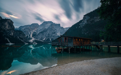 A famous boathouse at Braies Lake Lago di Braies, Pragser wildsee in the moonlight. Trentino Alto Adidge, Dolomites mountains, Italy.