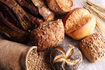 Different kinds of bread and bread rolls on board. Kitchen or bakery poster design.