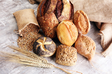 Different kinds of bread and bread rolls on board. Kitchen or bakery poster design.