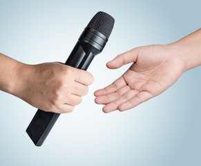 Hand holding microphone on blue background,Get  microphone
