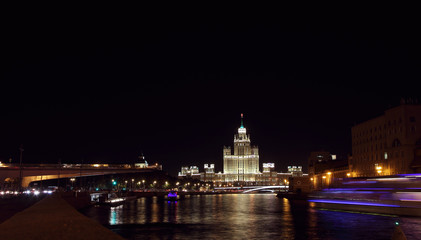 Fototapeta na wymiar View of Vysotka on Kotelnicheskaya Embankment and Moscow River in the evening..