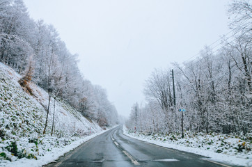 Obraz premium Amazing winter view along the road from Furano to Biei, located in Hokkaido, Japan famous for it's blue pond. Driving in Hokkaido is amazing, the road-trip was full with amazing view of natural scene.