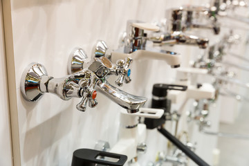 Kitchen faucets on shelf closeup, plumbing shop