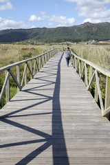 Obraz premium Young Woman on Walkway at Beach in Laxe; Fisterra