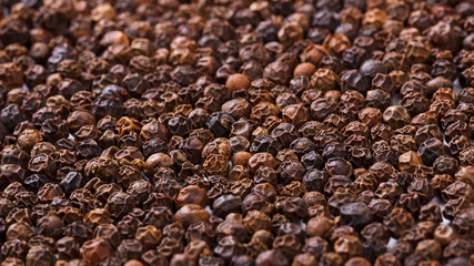 Black pepper corns background, macro, close up shot