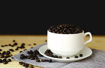 black seed coffee in white cup on wood table