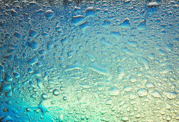 Complementary colors oil drops and water drops on glass,abstract background