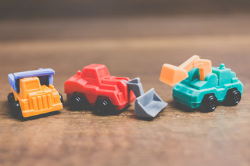 Fototapeta premium Toy construction machinery on wooden background