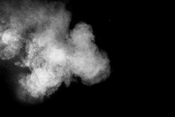 Launched white powder isolated on black background.