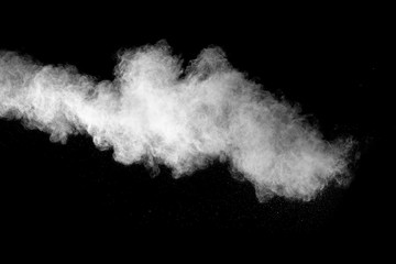 Launched white powder isolated on black background.